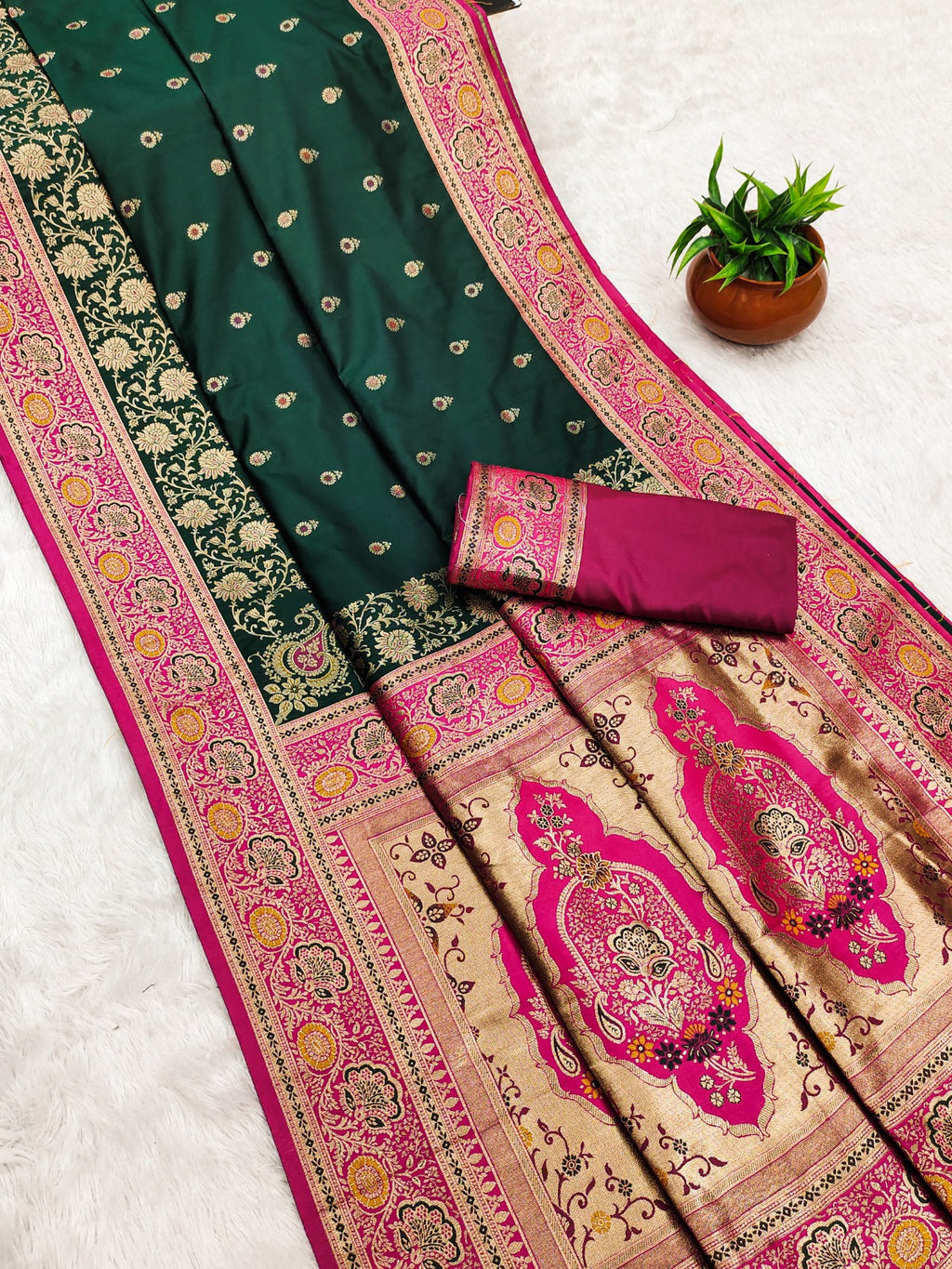 Traditional saree with green and pink patterns on a white background