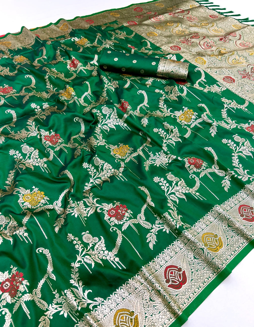 Green saree with floral patterns on a white background