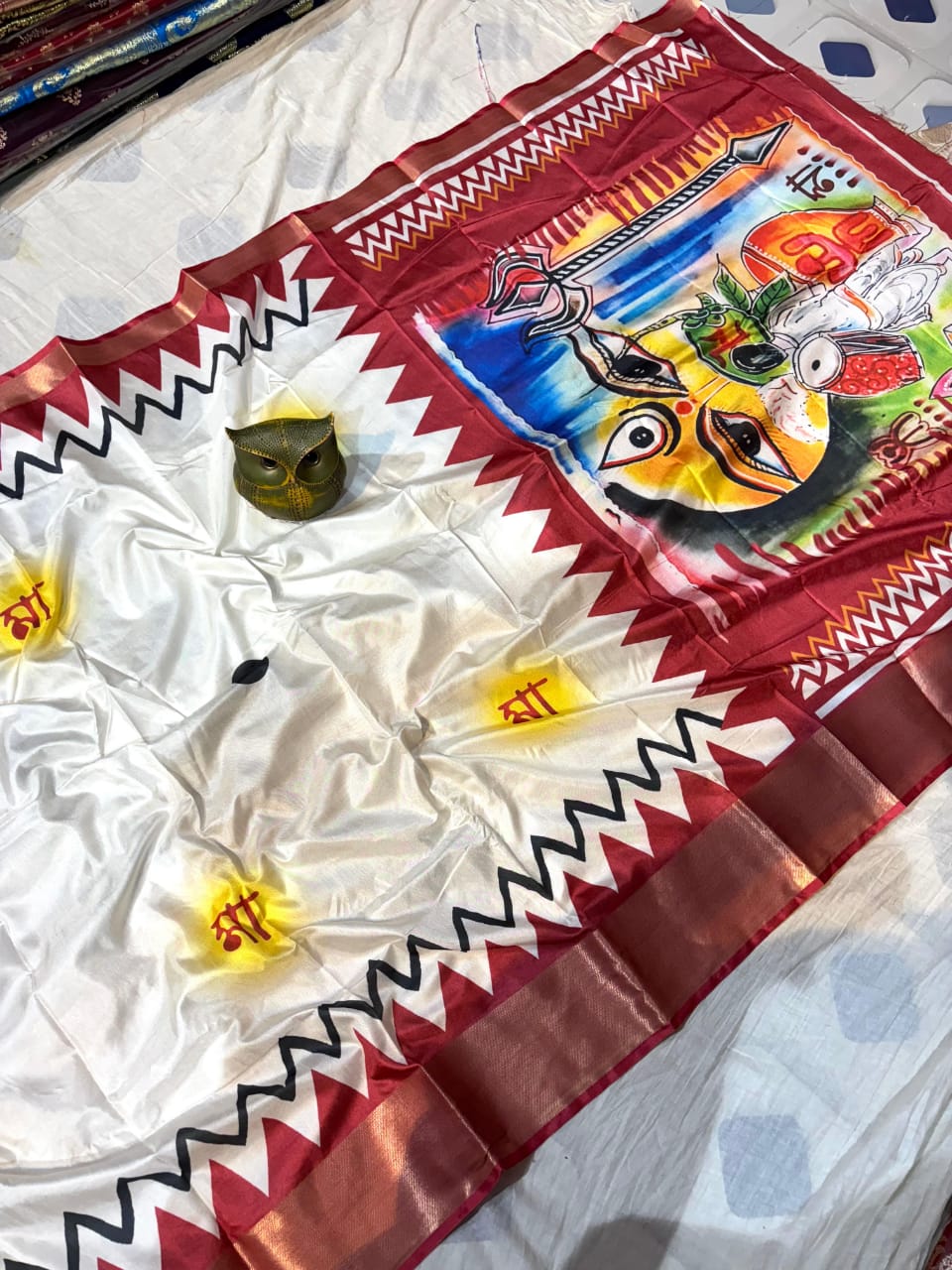 Beautiful Saree with colorful design of Maa Ambe on a white surface