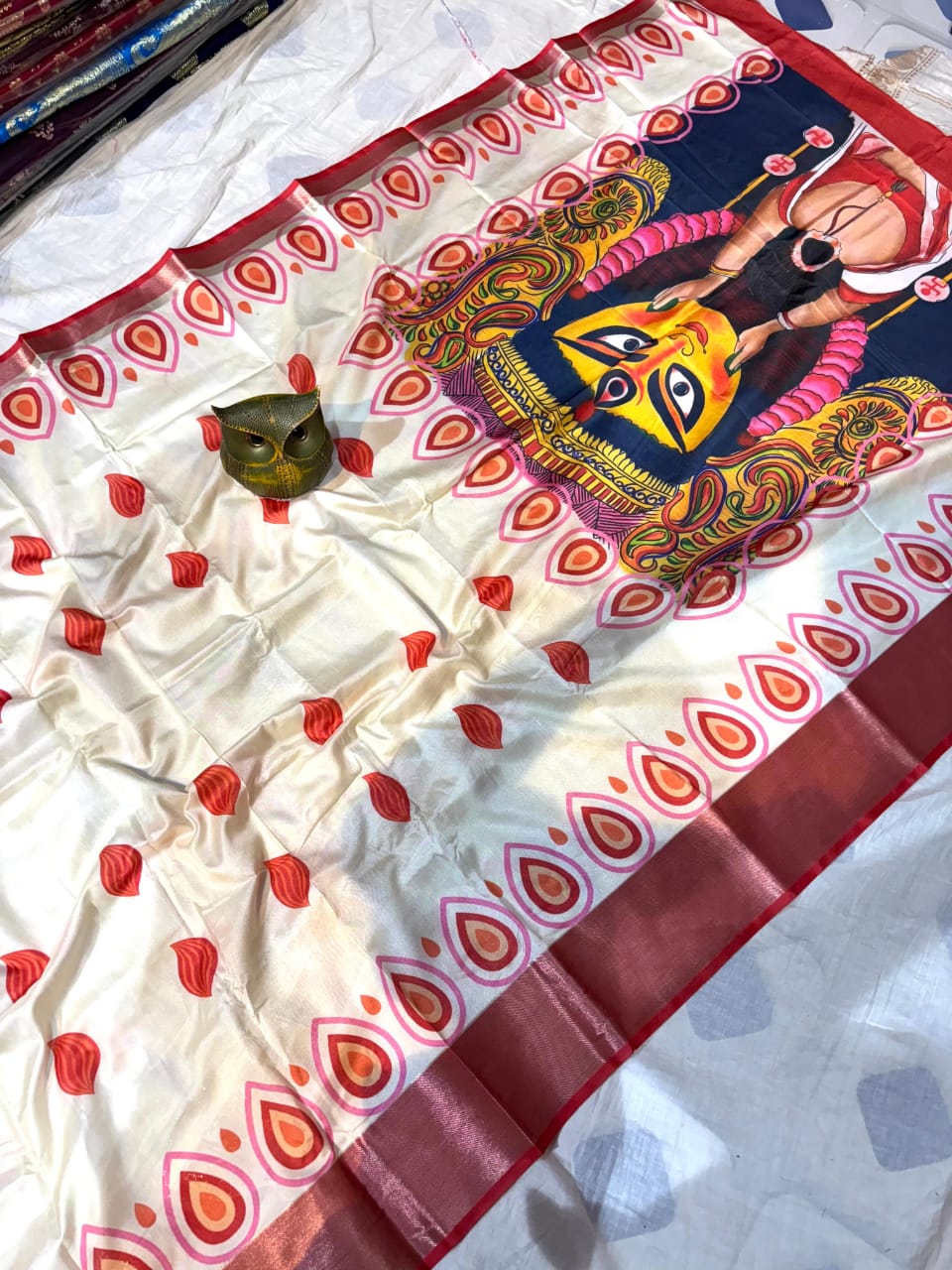 Decorative saree with a colorful design of Devi Durga on a white background