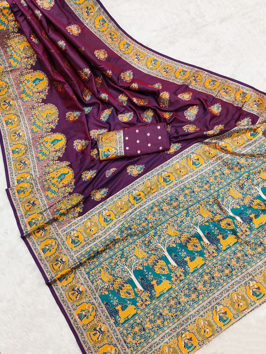 Decorative purple and teal fabric with intricate patterns on a light gray background