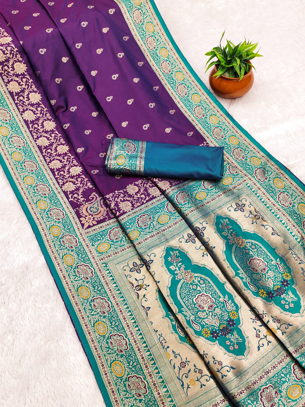 Saree with purple and green patterns on a white background