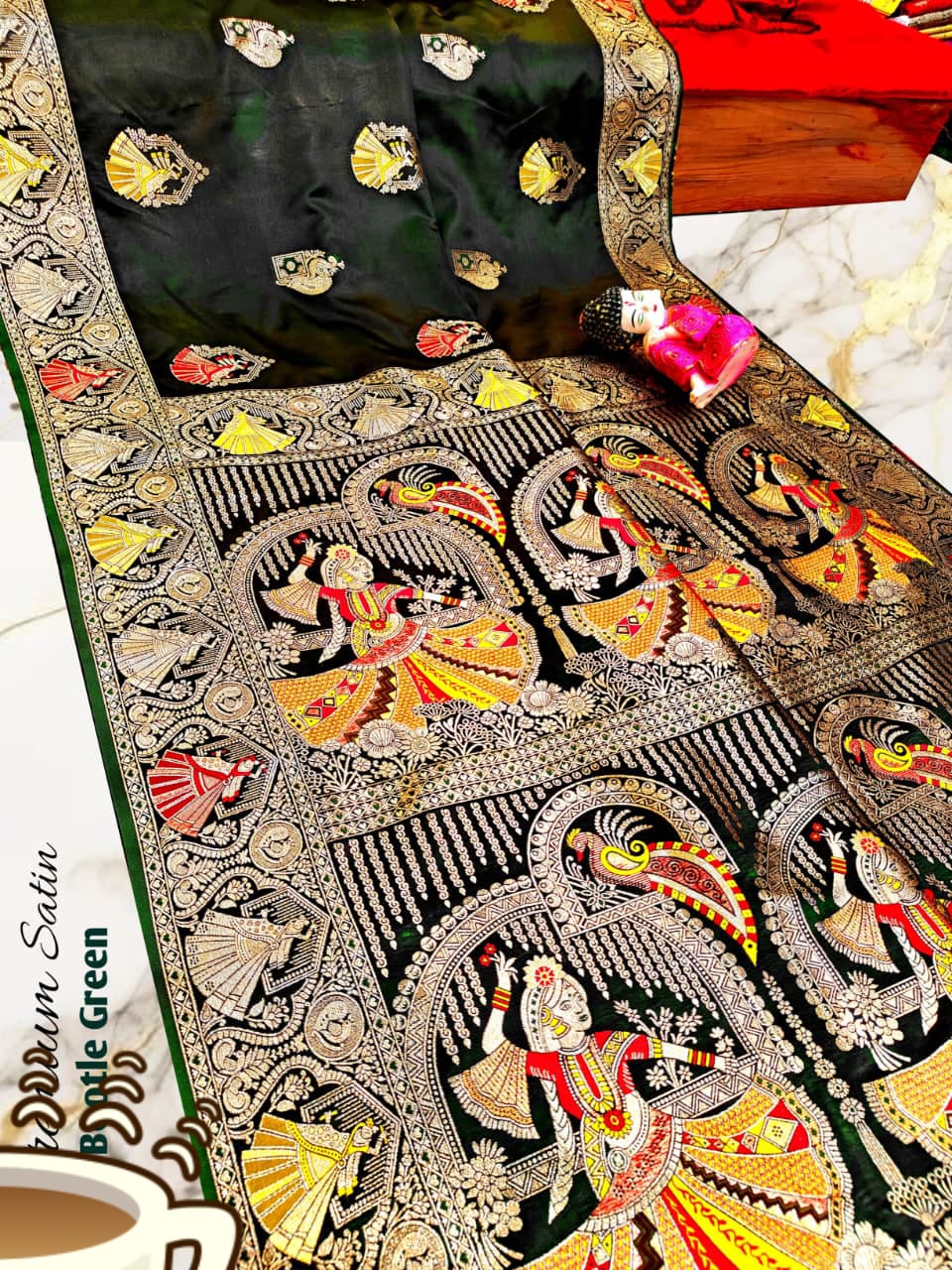 Decorative saree with intricate patterns and embroidery on a table.
