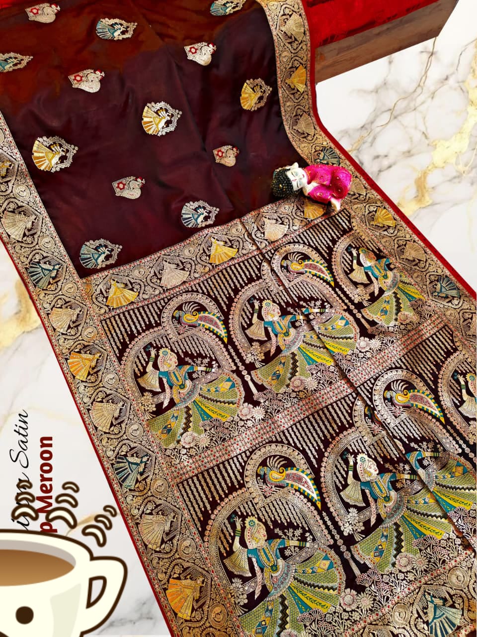 Decorative saree with intricate patterns on a table