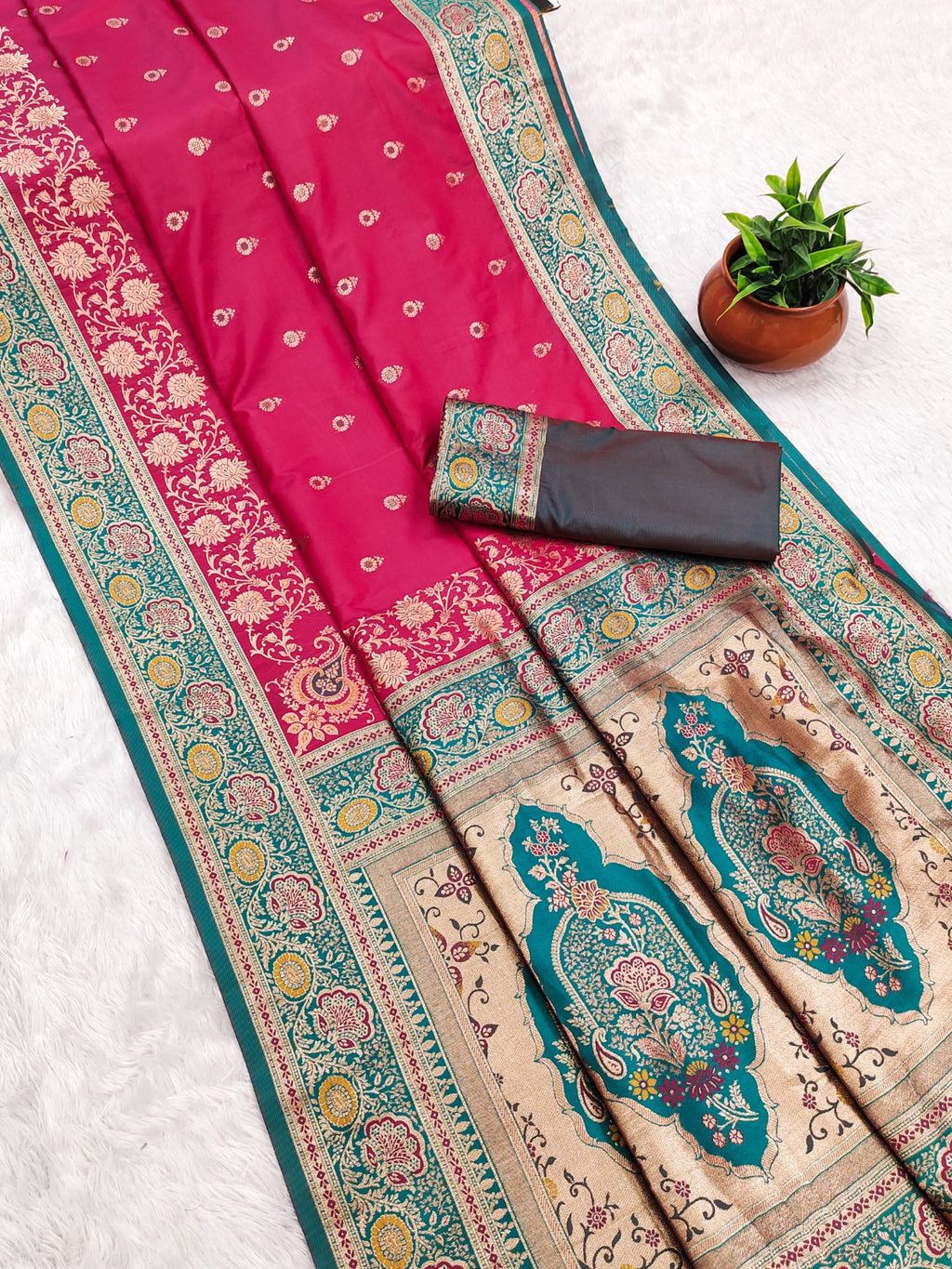 Saree with pink and blue patterns on a white background